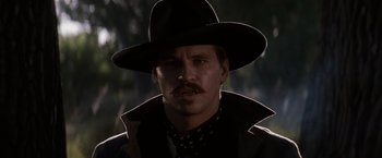 Movie still from “Tombstone” (1993), directed by George P. Cosmatos – A person wearing a hat; Close Up shot, Low angle