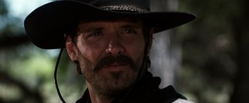 Movie still from “Tombstone” (1993), directed by George P. Cosmatos – A person wearing a cowboy hat; Close Up shot, Low angle