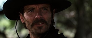 Movie still from “Tombstone” (1993), directed by George P. Cosmatos – A person wearing a cowboy hat; Close Up shot, Low angle