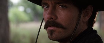 Movie still from “Tombstone” (1993), directed by George P. Cosmatos – A person wearing a hat; Close Up shot, Low angle