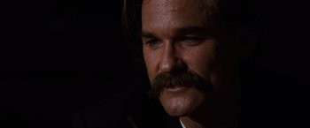 Movie still from “Tombstone” (1993), directed by George P. Cosmatos – A person wearing a suit and tie; Close Up shot, Low angle