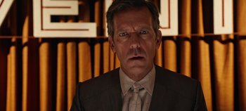 Movie still from “Tomorrowland” (2015), directed by Brad Bird – A person wearing a suit and tie; Close Up shot, Over the shoulder angle