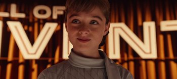 Movie still from “Tomorrowland” (2015), directed by Brad Bird – A young woman with short hair wearing a white shirt; Close Up shot, Low angle