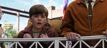 Movie still from “Tomorrowland” (2015), directed by Brad Bird – A young boy is looking over a railing; Close Up shot, Low angle