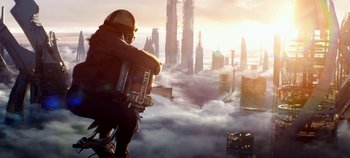 Movie still from “Tomorrowland” (2015), directed by Brad Bird – A man in a helmet standing on top of a building; Wide shot, Low angle