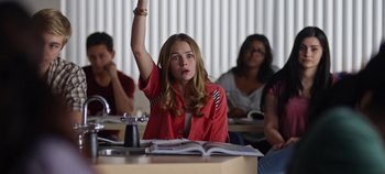Movie still from “Tomorrowland” (2015), directed by Brad Bird – A woman raising her hand in a class room; Medium shot, Low angle