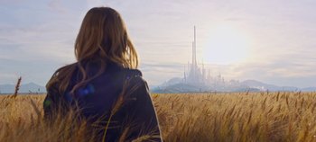 Movie still from “Tomorrowland” (2015), directed by Brad Bird – A woman standing in a field looking at a city in the distance; Extreme Wide shot, Low angle