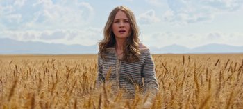 Movie still from “Tomorrowland” (2015), directed by Brad Bird – A woman standing in the middle of a wheat field; Medium shot, Low angle