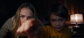 Movie still from “Tomorrowland” (2015), directed by Brad Bird – Two young children sitting in front of a television; Close Up shot, Low angle