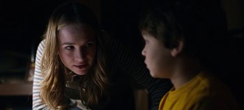 Movie still from “Tomorrowland” (2015), directed by Brad Bird – A woman and a boy are talking in a dark room; Close Up shot, Over the shoulder angle