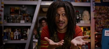 Movie still from “Tomorrowland” (2015), directed by Brad Bird – A man with dreadlocks is making a funny face; Close Up shot, High angle