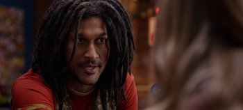 Movie still from “Tomorrowland” (2015), directed by Brad Bird – A person with dreads looking at the camera; Close Up shot, Over the shoulder angle