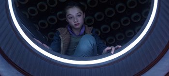 Movie still from “Tomorrowland” (2015), directed by Brad Bird – A young girl sitting in front of a round mirror; Close Up shot, Low angle