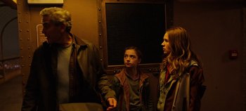 Movie still from “Tomorrowland” (2015), directed by Brad Bird – A group of people standing next to each other in a room; Medium shot, Low angle