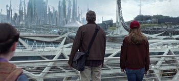 Movie still from “Tomorrowland” (2015), directed by Brad Bird – A man and a woman looking out at a futuristic city; Wide shot, Over the shoulder angle