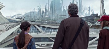 Movie still from “Tomorrowland” (2015), directed by Brad Bird – A man and a woman looking out a window at a futuristic city; Wide shot, High angle
