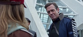 Movie still from “Tomorrowland” (2015), directed by Brad Bird – A man standing next to another man; Close Up shot, Over the shoulder angle