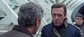 Movie still from “Tomorrowland” (2015), directed by Brad Bird – Two men are talking to each other outside; Close Up shot, Over the shoulder angle