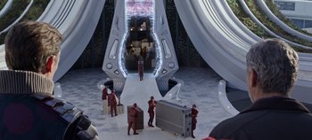 Movie still from “Tomorrowland” (2015), directed by Brad Bird – A group of people standing in a room; Extreme Wide shot, High angle