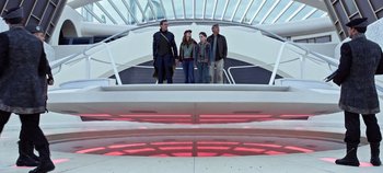 Movie still from “Tomorrowland” (2015), directed by Brad Bird – A group of people standing in front of a building; Wide shot, Low angle