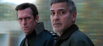 Movie still from “Tomorrowland” (2015), directed by Brad Bird – Two men are standing next to each other; Close Up shot, Low angle