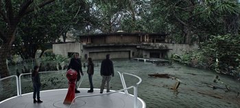 Movie still from “Tomorrowland” (2015), directed by Brad Bird – Three people are standing on a boat in the water; Wide shot, High angle