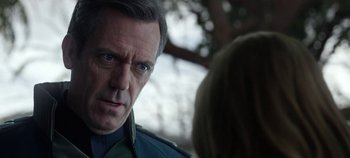 Movie still from “Tomorrowland” (2015), directed by Brad Bird – A man in a police uniform talking to a woman in front of a tree; Close Up shot, Over the shoulder angle