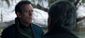 Movie still from “Tomorrowland” (2015), directed by Brad Bird – A man wearing a uniform talking to another man; Close Up shot, Over the shoulder angle