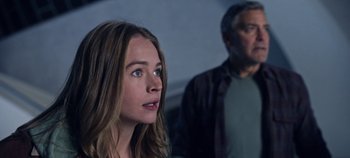 Movie still from “Tomorrowland” (2015), directed by Brad Bird – A woman and a man standing next to each other in a room; Close Up shot, Over the shoulder angle