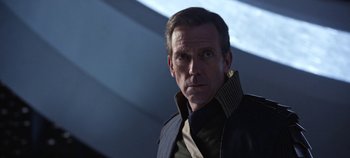Movie still from “Tomorrowland” (2015), directed by Brad Bird – A person wearing a suit and tie; Close Up shot, Over the shoulder angle