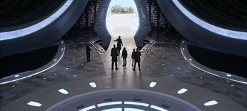Movie still from “Tomorrowland” (2015), directed by Brad Bird – A group of people standing in front of an opening in a building; Extreme Wide shot, High angle