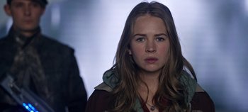 Movie still from “Tomorrowland” (2015), directed by Brad Bird – A woman with long brown hair wearing a hooded jacket; Close Up shot, Over the shoulder angle
