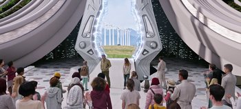 Movie still from “Tomorrowland” (2015), directed by Brad Bird – A group of people standing in front of an entrance to a field; Wide shot, High angle
