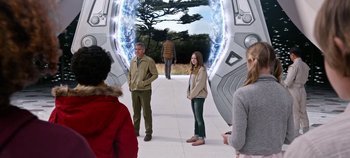 Movie still from “Tomorrowland” (2015), directed by Brad Bird – A man and a woman standing in front of an entrance; Wide shot, Over the shoulder angle