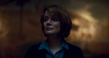 Movie still from “Too Old to Die Young” (2019), directed by Nicolas Winding Refn – A person with short hair wearing a suit; Close Up shot, Low angle