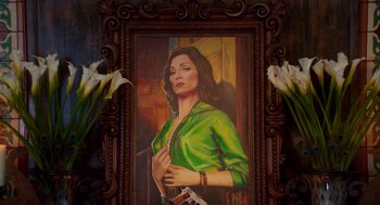 Movie still from “Too Old to Die Young” (2019), directed by Nicolas Winding Refn – A painting of a woman in a green shirt; Close Up shot, Overhead angle