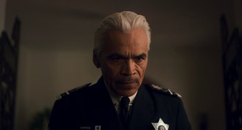 Movie still from “Too Old to Die Young” (2019), directed by Nicolas Winding Refn – A man in a police uniform with a stern look on his face; Close Up shot, Low angle