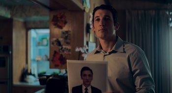 Movie still from “Too Old to Die Young” (2019), directed by Nicolas Winding Refn – A man holding up a picture of himself; Close Up shot, Low angle