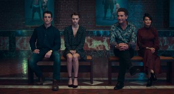 Movie still from “Too Old to Die Young” (2019), directed by Nicolas Winding Refn – A group of people sitting on top of a wooden bench; Wide shot, High angle