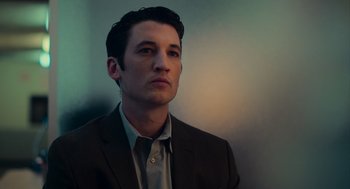 Movie still from “Too Old to Die Young” (2019), directed by Nicolas Winding Refn – A man wearing a suit and tie looking to his left; Close Up shot, Low angle