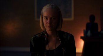 Movie still from “Too Old to Die Young” (2019), directed by Nicolas Winding Refn – A woman with blonde hair is standing in the dark; Close Up shot, Over the shoulder angle