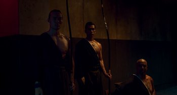 Movie still from “Too Old to Die Young” (2019), directed by Nicolas Winding Refn – A couple of men standing next to each other; Medium shot, Low angle