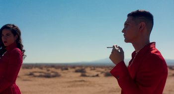 Movie still from “Too Old to Die Young” (2019), directed by Nicolas Winding Refn – A man in a red jacket is smoking a cigarette; Medium shot, Low angle