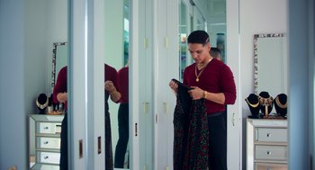 Movie still from “Too Old to Die Young” (2019), directed by Nicolas Winding Refn – A woman looking at her cell phone in a mirror; Medium shot, Low angle