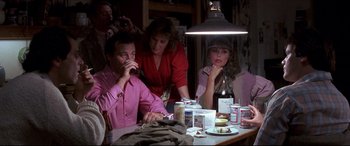 Movie still from “Tootsie” (1982), directed by Sydney Pollack – A group of people sitting at a table with a cat; Medium shot, High angle
