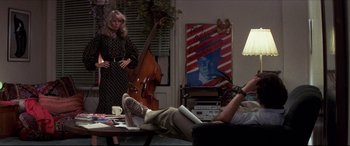 Movie still from “Tootsie” (1982), directed by Sydney Pollack – A man laying on the ground in a living room; Wide shot, Over the shoulder angle