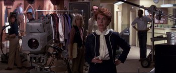Movie still from “Tootsie” (1982), directed by Sydney Pollack – A group of people standing in a room with bicycles; Medium shot, Over the shoulder angle