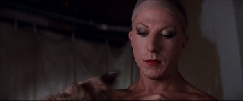 Movie still from “Tootsie” (1982), directed by Sydney Pollack – A man with a bandage on his head is brushing his hair; Close Up shot, Low angle