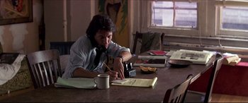 Movie still from “Tootsie” (1982), directed by Sydney Pollack – A man sitting at a table writing on a piece of paper; Medium shot, Low angle
