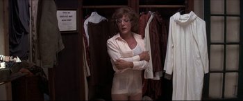 Movie still from “Tootsie” (1982), directed by Sydney Pollack – An older woman in a white outfit standing in front of a closet; Medium shot, Over the shoulder angle